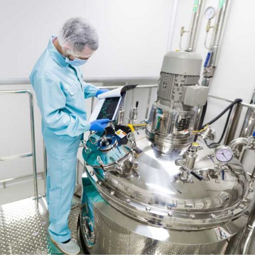 Quality image 2 man wearing mask studying data in front of a machine