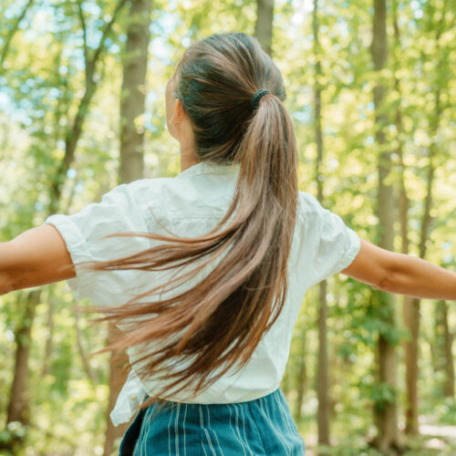 Happy woman in forest with open arms from behind breathing clean air. Environment, no pollution healthy natural living lifestyle. Free spirit in the woods. Sustainability Image 5